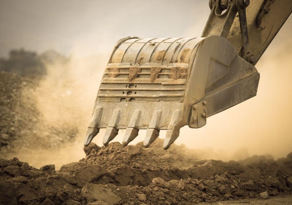 Excavator+working+with+red+soil+and+dusty_396912907